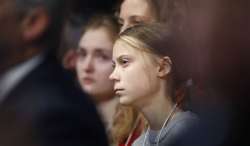 Swedish environmental activist Greta Thunberg listens as U.S. President Donald Trump addresses the W