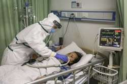 In this Thursday, Feb. 6, 2020, photo, a nurse feeds water to a patient in the isolation ward for 20