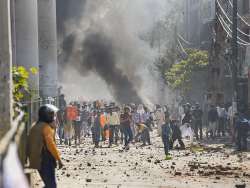 Protestors throw brick-bats during clashes between a group of anti-CAA protestors and supporters of the new citizenship act, at Jafrabad in north-east Delhi, Monday (PTI)