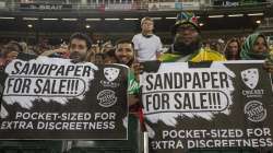 Fans hold posters during the 1st T20 cricket match between South Africa and Australia at Wanderers stadium in Johannesburg, South Africa, Friday, Feb. 21