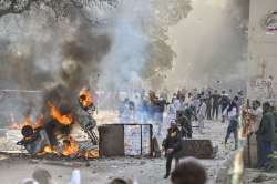 Vehicles set ablaze as protestors throw brick-bats during clashes between a group of anti-CAA protestors and supporters of the new citizenship act, at Jafrabad in north-east Delhi, Monday (PTI)