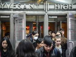 Students at Stuyvesant High School leave after classes end for the week, Friday, March 13, 2020, in 