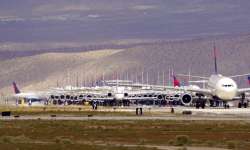 Delta Airlines aircraft are stored at Southern California Logistics Airport, Wednesday, March 25, 2020, in Victorville, Calif. As demand for air travel drops amid the coronavirus outbreak, commercial aircraft are being parked at facilities that include remote desert airports, including the Southern California Logistics Airport in Victorville about 90 miles northeast of Los Angeles. (AP Photo/Mark J. Terrill)