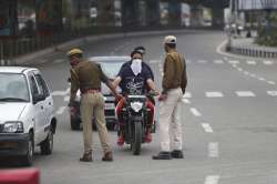 Policemen question commuters during lockdown in Jammu, India, Wednesday, March 25, 2020. The world's