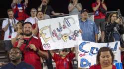 A young United States fan holds up a sign advocating for equal pay for women's soccer players after the United States defeated Japan in a SheBelieves Cup women's soccer match, Wednesday, March 11, 2020 at Toyota Stadium in Frisco, Texas