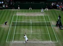 Roger Federer of Switzerland serves during the Men's Singles Final match against Rafael Nadal of Spain on day thirteen of the Wimbledon Lawn Tennis Championships at the All England Lawn Tennis and Croquet Club on July 6, 2008 in London, England