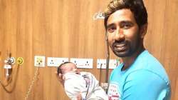 Wriddhiman Saha holding his baby boy