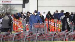 A person wears a mask as he stands in line at Costco Saturday, April 4, 2020, in Salt Lake City. The