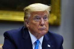 President Donald Trump listens during a conference call with banks on efforts to help small business