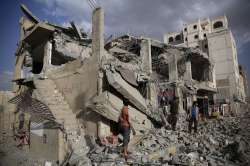 FILE - In this Monday, Jan. 25, 2016 photo, men inspect a house destroyed by a Saudi-led airstrike i