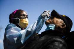 Dr. Ala Stanford administers a COVID-19 swab test on Wade Jeffries in the parking lot of Pinn Memori