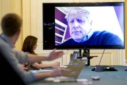 In this Saturday, March 28, 2020 handout photo provided by Number 10 Downing Street, Britain's Prime Minister Boris Johnson chairs the morning Covid-19 Meeting remotely after self isolating after testing positive for the coronavirus, at 10 Downing Street, London. British Prime Minister Boris Johnson has been admitted to a hospital with the coronavirus. Johnson’s office says he is being admitted for tests because he still has symptoms 10 days after testing positive for the virus.