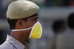 A policeman stands wearing a mask during a lockdown in Prayagraj, India, Monday, March 30, 2020. The