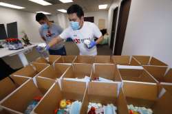 Kavkaz Express employees Bakha Tokkozhin, front, and Rollan Daniyar load up boxes of food to hand ou