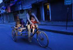 Saila Tamang, a Nepalese rickshaw puller returns to his rented room after looking for free food duri