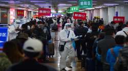 Passengers from Wuhan stand in lines designating where they will quarantine in Beijing, China