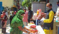 Madhya Pradesh Chief Minister Shivraj Singh Chouhan distributes food packets among poor people during a nationwide lockdown in the wake of coronavirus pandemeic, in Bhopal on March 30 (file photo)