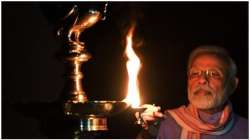 Prime Minister Narendra Modi lighting a diya at his residence in New Delhi on Sunday