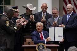 Law enforcement officials applaud after President Donald Trump signed an executive order on police r