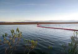 In this handout photo provided by the Russian Marine Rescue Service, rescuers work to prevent the sp