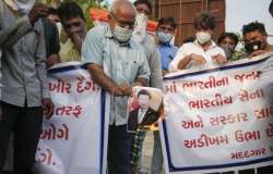 Ahmedabad: Demonstrators burn posters of Chinese President Xi Jinping during a protest against China, in Ahmedabad, Tuesday, June 16, 2020. 20 soldiers were killed in the Galwan Valley in eastern Ladakh on Monday night during a clash with Chinese troops in the first such incident involving fatalities after a gap of 45 years, signalling a massive escalation in the five-week border standoff in the sensitive region.? (PTI Photo)