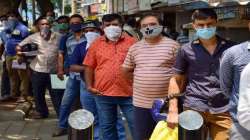 Representational image of people with masks queuing up at a grocery store in Punjab (file photo)