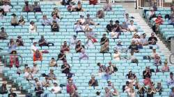 Spectators observe social distancing in the stands during the friendly cricket match at the Oval, London, Sunday, July 26, 2020.