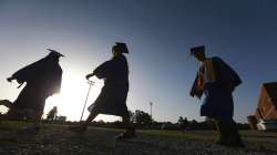 Saltillo High School seniors make their way to the football field as the sun begins to set for their graduation ceremony in Saltillo, Miss. The number of high school seniors applying for US federal college aid plunged in the weeks following the sudden closure of school buildings this spring — a time when students were cut off from school counselors, and families hit with financial setbacks were reconsidering plans for higher education.