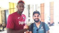 Jason Holder with Virat Kohli