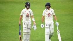 Ollie Pope and Jos Buttler of England leave the field as bad light stops play during Day One of the Ruth Strauss Foundation Test, the Third Test in the #RaiseTheBat Series match between England and the West Indies at Emirates Old Trafford on July 24, 2020 in Manchester, England.