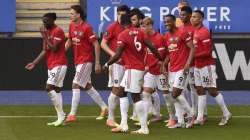 Manchester United's Bruno Fernandes celebrates with teammates after scoring his side's opening goal from the penalty spot during the English Premier League soccer match between Leicester City