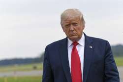 President Donald Trump walks over to speak with the press after arriving on Air Force One at Morrist