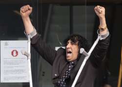 Mosque shooting victim Taj Mohammad Kamran reacts as he leaves the Christchurch High Court after the