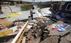 Benjamin Luna helps recover items from the children's wing of the First Pentecostal Church that was 