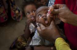 In this Wednesday, April 24, 2013 file photo, a Somali baby receives a polio vaccine at the Medina Maternal Child Health center in Mogadishu, Somalia. Health authorities on Tuesday, Aug. 25, 2020 are expected to declare the African continent free of the wild poliovirus after decades of effort, though cases of vaccine-derived polio are still sparking outbreaks of the paralyzing disease in more than a dozen countries.