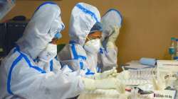 Kolkata Municipal Corporation (KMC) health workers prepare before collecting swab samples of residen