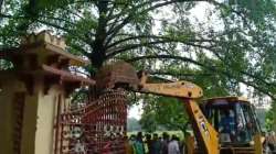 A bulldozer demolishing the fencing?