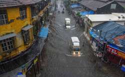 Mumbai: Vehicles ply on a waterlogged street during heavy rains, at Byculla area in Mumbai, Wednesday, Aug. 5, 2020. 