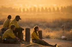 Firefighters rest during a wildfire in Yucaipa, Calif., Saturday, Sept. 5, 2020. Firefighters trying