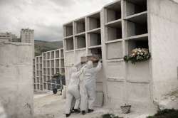 In this Sept. 24, 2020, file photo, cemetery workers place the coffin containing the remains of Jose