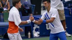 Novak Djokovic, of Serbia, shakes hands with Pablo Carreno Busta, of Spain, after defaulting the match during the fourth round of the US Open tennis championships, Sunday, Sept. 6