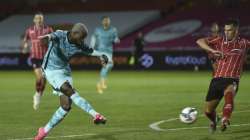 Liverpool's Divock Origi, left, shoots and scores his sides 7th goal during the English League Cup third round soccer match between Lincoln City and Liverpool at the LNER stadium, Lincoln, England, Thursday, Sept. 24