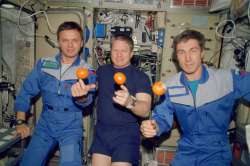 NASA's Expedition 1 crew members pose with fresh oranges onboard the Zvezda Service Module of the Ea