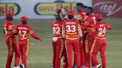 Zimbabwe's pacer Blessing Muzarabani, third right, celebrates with teammates after taking the wicket of Pakistani batsman Babar Azam during the 3rd one-day international cricket match at the Pindi Cricket Stadium, in Rawalpindi, Pakistan, Tuesday, Nov. 3