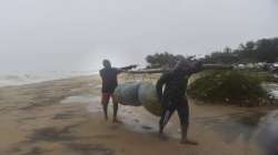 Fishermen move towards a safer place from a coastal area, as Cyclone Nivar is expected to make landf