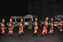 In this Nov. 18, 2019, photo released by China's Xinhua News Agency, rescuers prepare to enter a coa