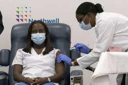 Sandra Lindsay, left, a nurse at Long Island Jewish Medical Center, is inoculated with the Pfizer-BioNTech COVID-19 vaccine by Dr. Michelle Chester, Monday, Dec. 14, 2020, in the Queens borough of New York.?
?