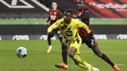 Frankfurt's Evan N'Dicka, right, and Dortmund's Youssoufa Moukoko challenge for the ball during a German Bundesliga soccer match between Eintracht Frankfurt and Borussia Dortmund in Frankfurt, Germany, Saturday, Dec. 5