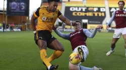 Wolverhampton Wanderers' Adama Traore, left, and Aston Villa's Matt Targett challenge for the ball during the English Premier League soccer match between Wolverhampton and Aston Villa at Molineux Stadium in Wolverhampton, England, Saturday, Dec.12