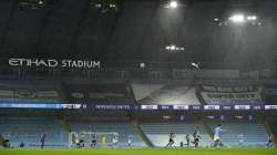 Players in the torrential rain during the English Premier League soccer match between Manchester City and Newcastle United at the Etihad stadium in Manchester, Saturday, Dec. 26